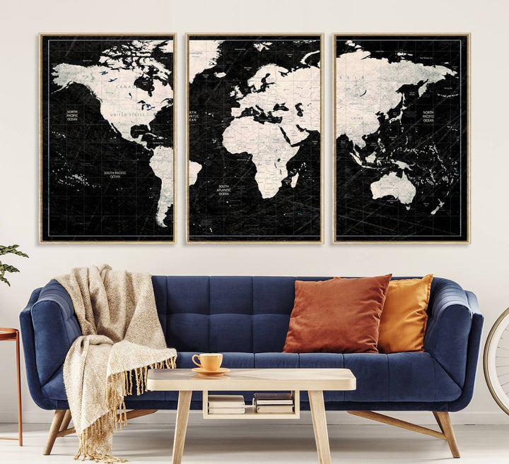 A bold global style framed black and white world map canvas print, presented in three panels, perfect for modern home or office decor.