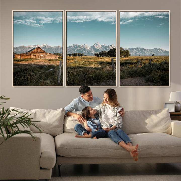 A rustic farmhouse with a wooden barn set against majestic mountain peaks under a soft blue sky, evoking peaceful countryside charm.
