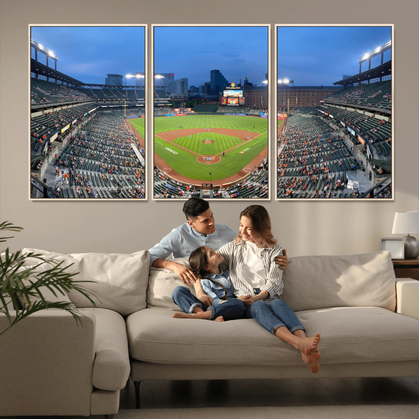 Wide panoramic view of a baseball stadium at dusk with players on the field, stadium lights illuminating the scene, and a sparse crowd of spectators in the stands.