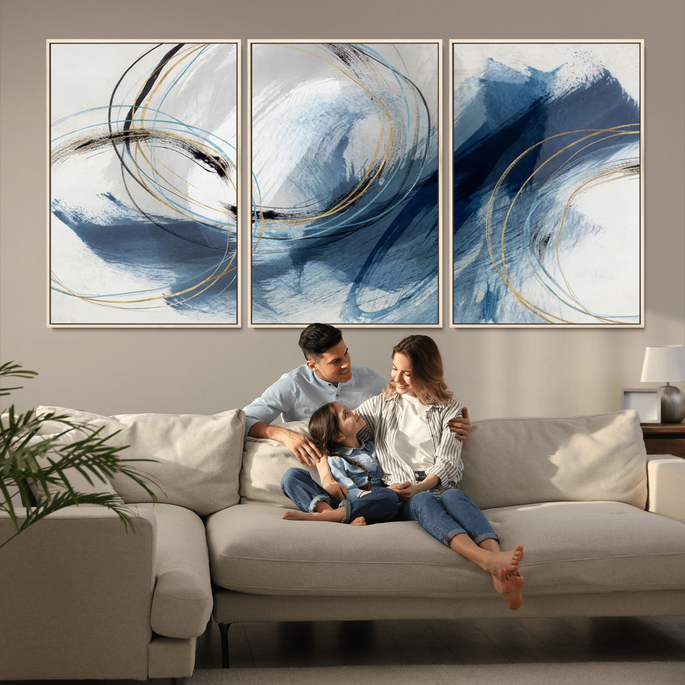 Abstract wall art featuring dynamic brush strokes in shades of blue and gray, overlaid with delicate circular line patterns in gold, black, and light blue on a white background.