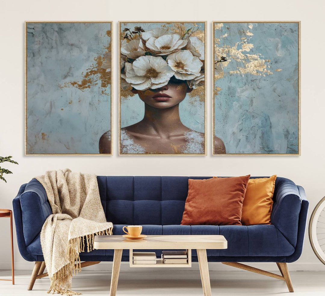 Golden Petal Wall Art: A womans face adorned with a gold floral design on a teal background, presented in a 3-panel modern glam canvas.