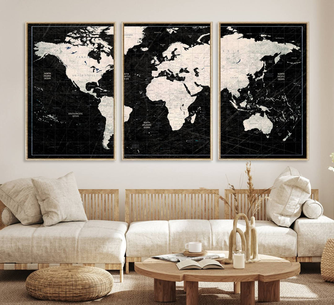 A bold global style framed black and white world map canvas print, presented in three panels, perfect for modern home or office decor.