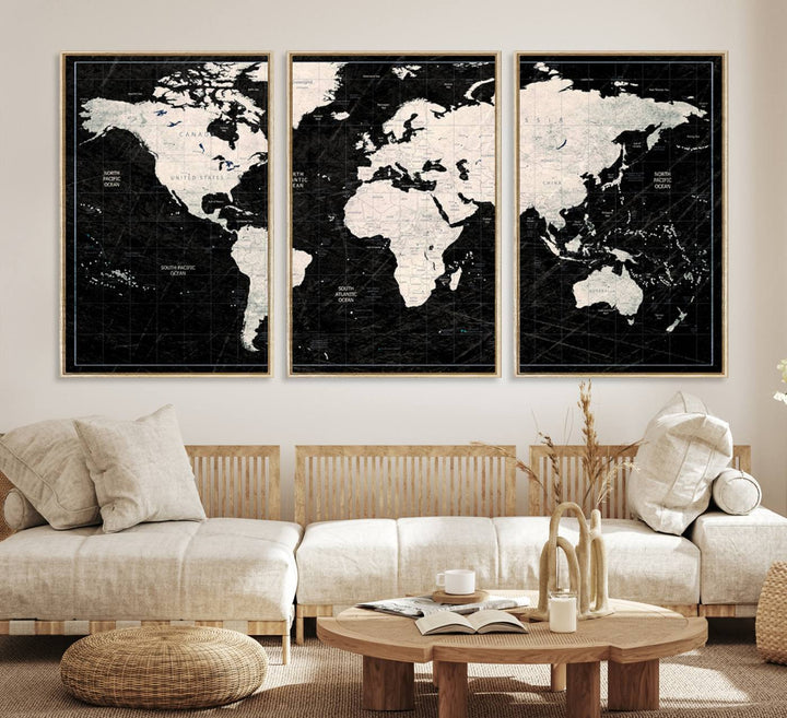 A bold global style framed black and white world map canvas print, presented in three panels, perfect for modern home or office decor.