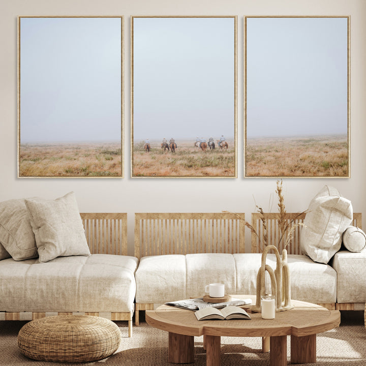A group of horseback riders moving through a fog-shrouded field, evoking a calm Western scene with golden grasses and soft horizons.