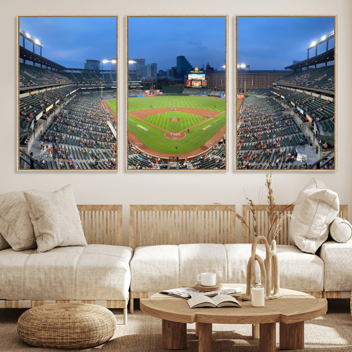 Wide panoramic view of a baseball stadium at dusk with players on the field, stadium lights illuminating the scene, and a sparse crowd of spectators in the stands.