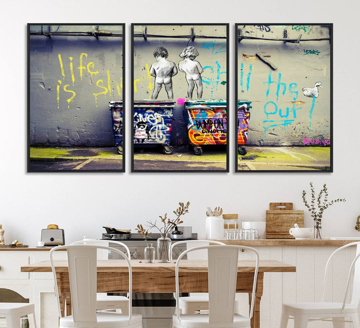 Banksys Life is Short graffiti, featuring kids and text, decorates the wall as a striking piece of framed canvas art.