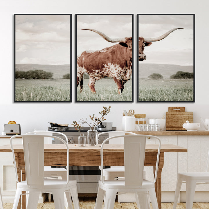 Canvas of a Texas longhorn standing in a grassy field with mountains in the background, ideal for rustic or country-style western wall decor.