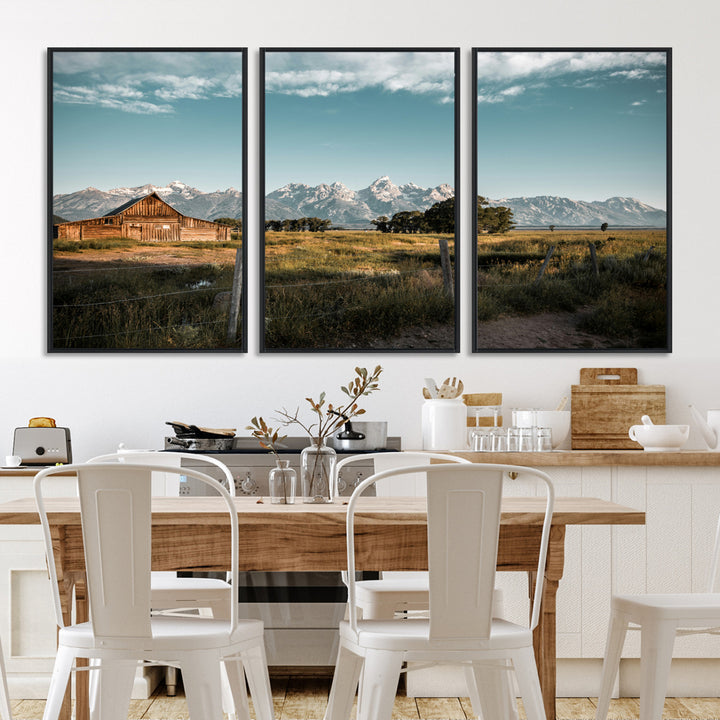 A rustic farmhouse with a wooden barn set against majestic mountain peaks under a soft blue sky, evoking peaceful countryside charm.