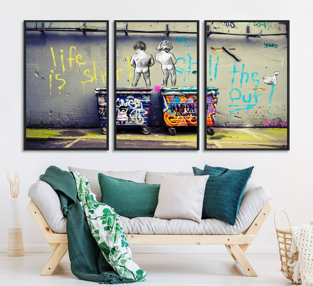 Banksys Life is Short graffiti, featuring kids and text, decorates the wall as a striking piece of framed canvas art.