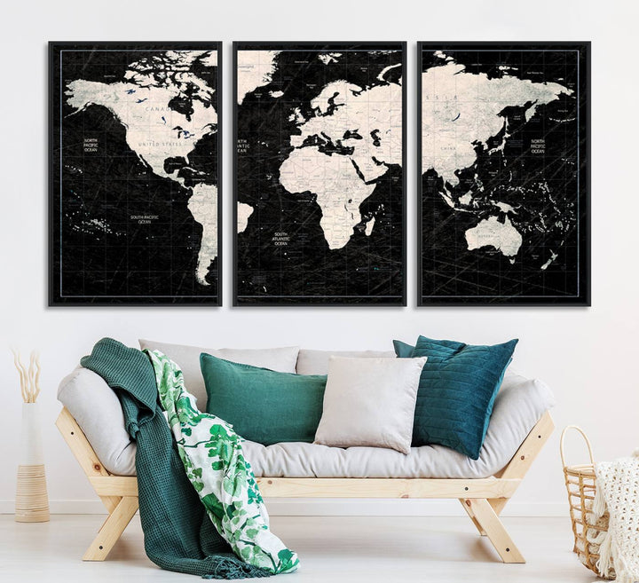 A bold global style framed black and white world map canvas print, presented in three panels, perfect for modern home or office decor.