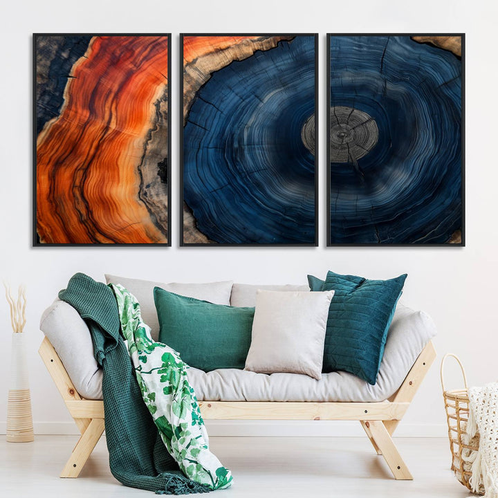 Abstract Tree Ring Wall Art Print on canvas featuring vibrant blue, orange, and brown rings with a natural rustic wood texture. Free shipping available!.