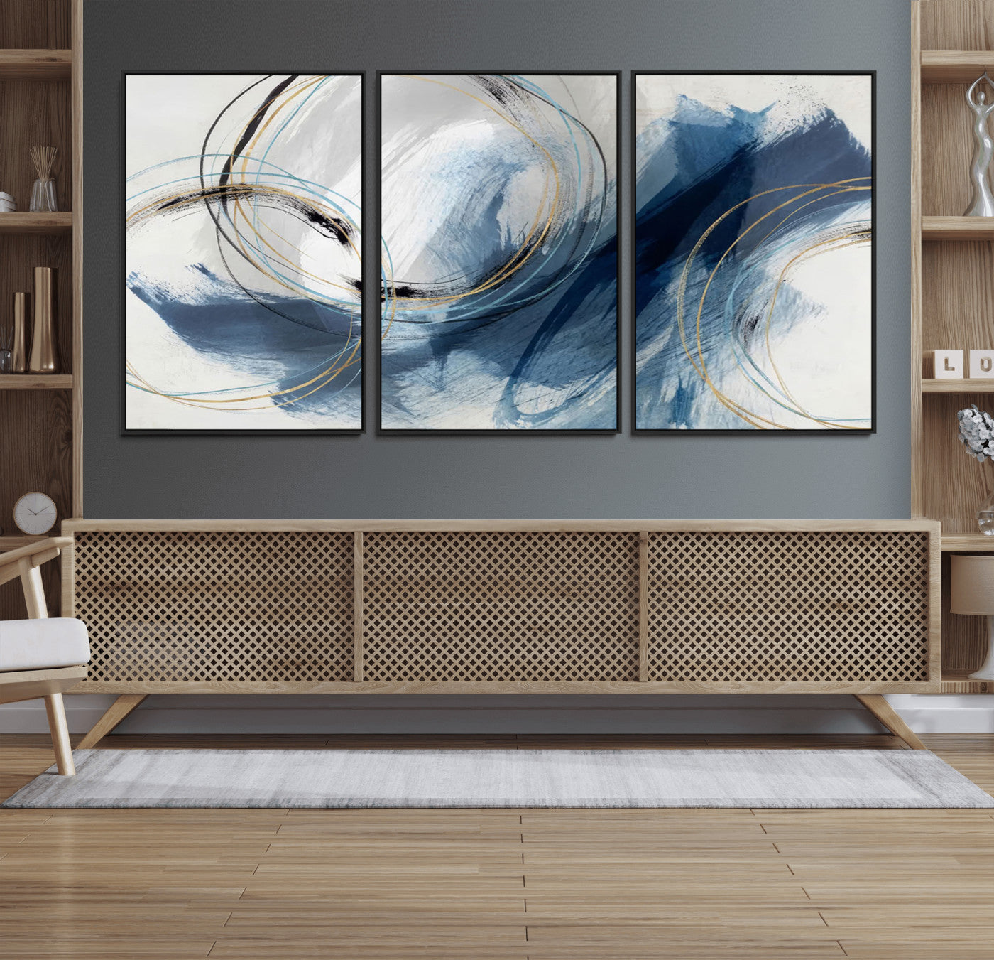 Abstract wall art featuring dynamic brush strokes in shades of blue and gray, overlaid with delicate circular line patterns in gold, black, and light blue on a white background.