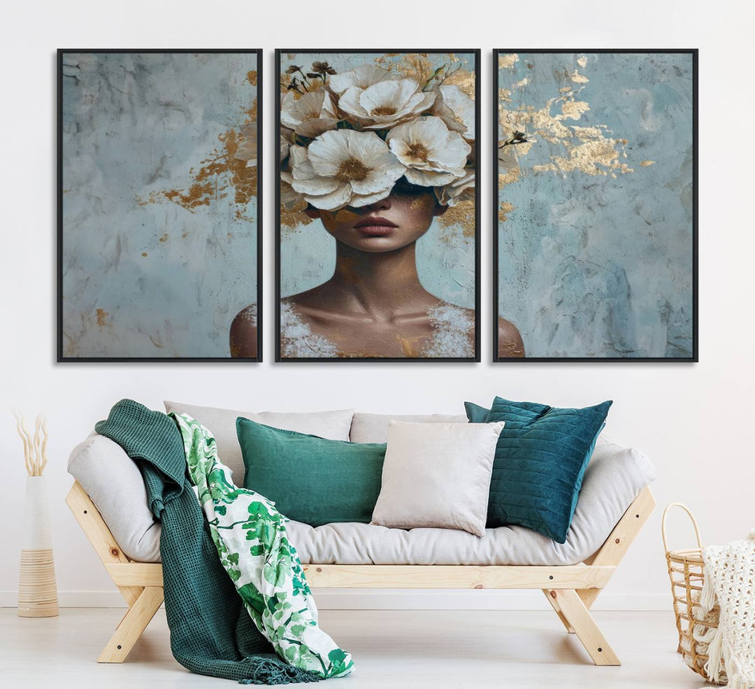 Golden Petal Wall Art: A womans face adorned with a gold floral design on a teal background, presented in a 3-panel modern glam canvas.