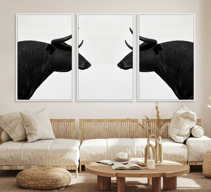 A framed canvas print featuring two black bull silhouettes, perfect for modern rustic decor.