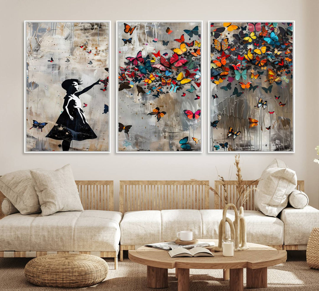 The Banksy Butterfly Girl 3-Piece Modern Graffiti Canvas Wall Art features a silhouette of a girl reaching for butterflies.