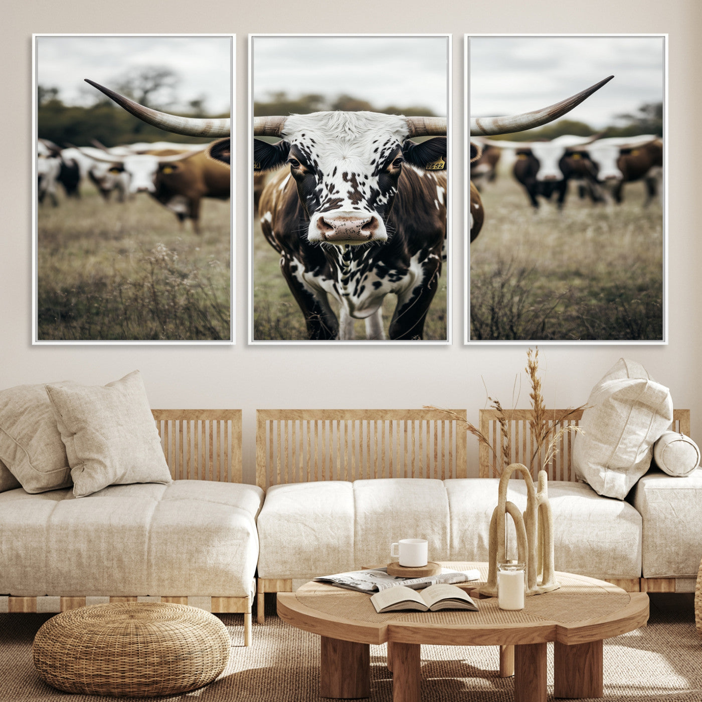 Canvas of a speckled Texas longhorn standing boldly in a field with a herd behind, perfect for rustic western or farmhouse wall decor.