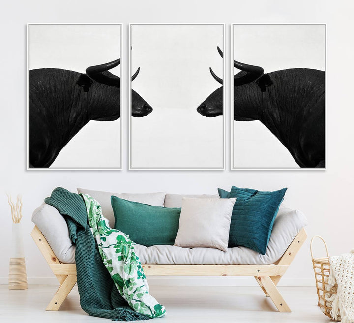 A framed canvas print featuring two black bull silhouettes, perfect for modern rustic decor.