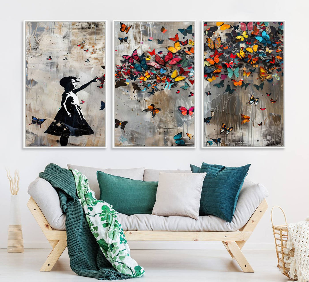 The Banksy Butterfly Girl 3-Piece Modern Graffiti Canvas Wall Art features a silhouette of a girl reaching for butterflies.