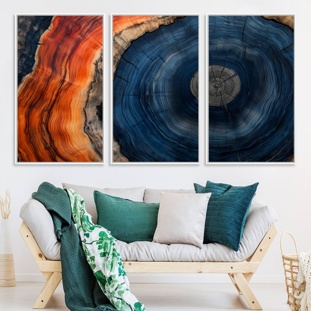 Abstract Tree Ring Wall Art Print on canvas featuring vibrant blue, orange, and brown rings with a natural rustic wood texture. Free shipping available!.