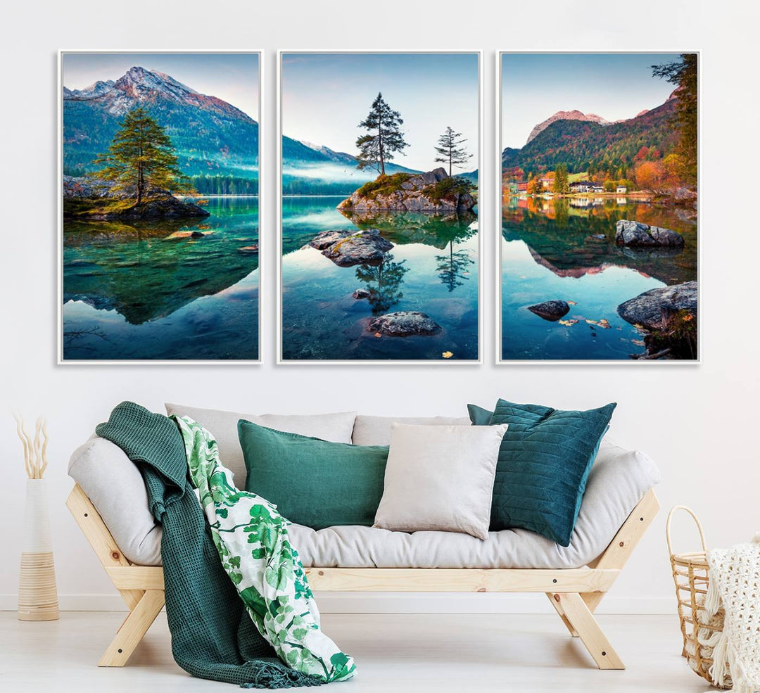 The 3-panel wall art showcases a serene mountain lake with rocky islands and trees, creating an ideal focal point for dining rooms or offices.