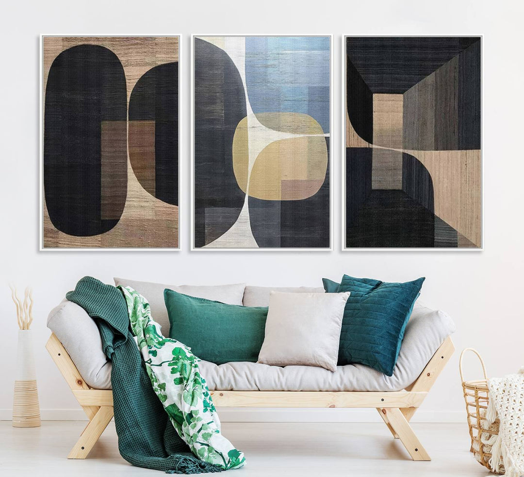 Abstract geometric wall art featuring black, gray, beige, and blue tones framed in a wooden border.