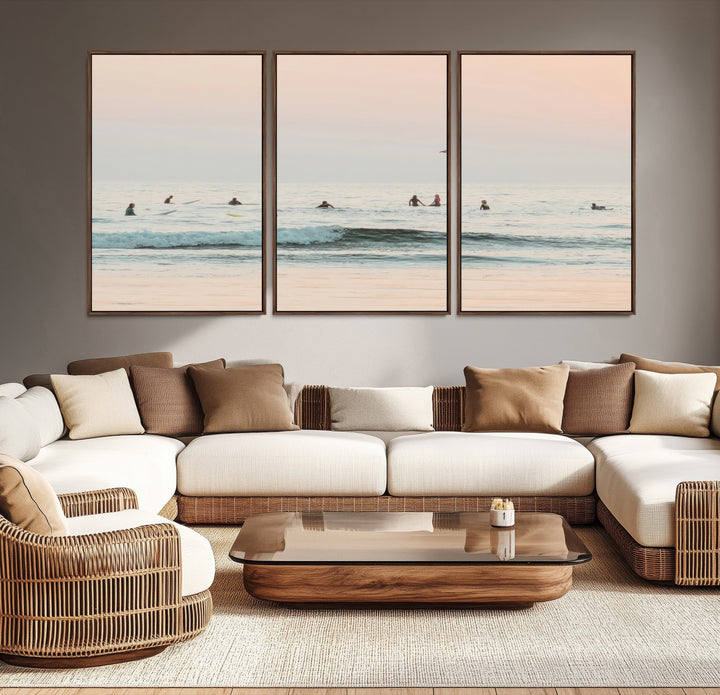 Dreamy photo of surfers waiting on soft pastel waves under a pink sunset sky, ideal for soft coastal minimalist or serene ocean-themed home decor.