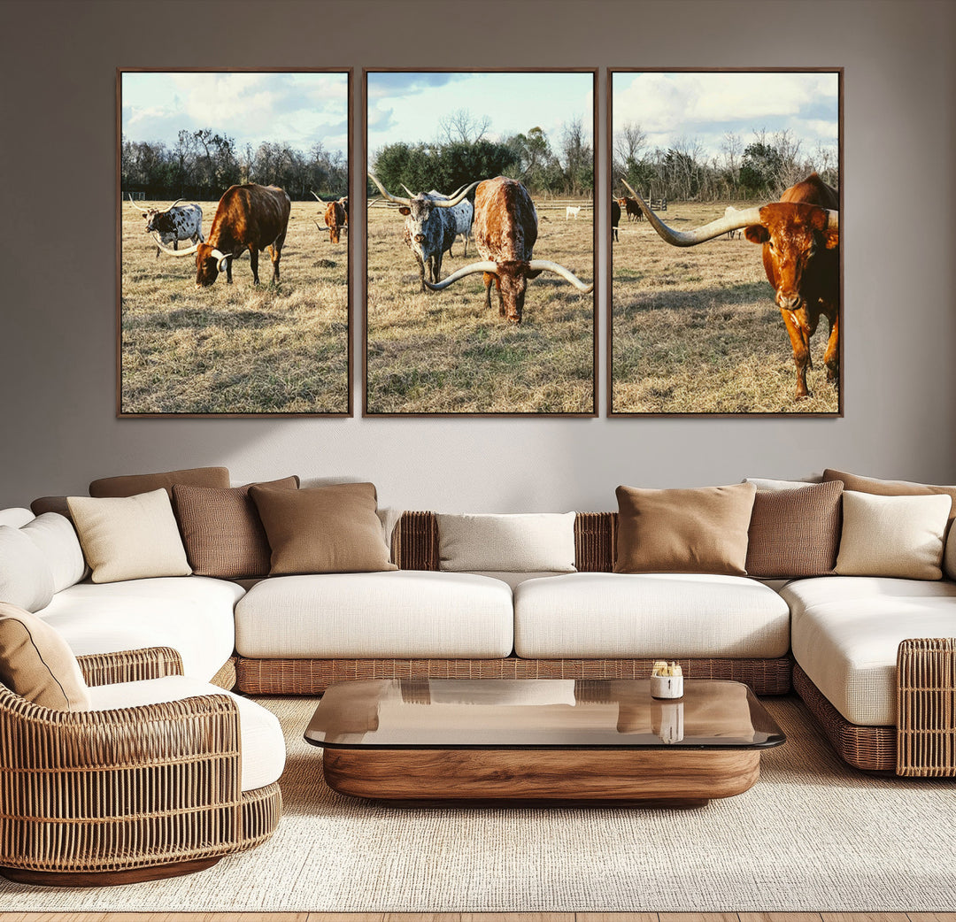 A herd of Texas Longhorn cattle grazing in an open field under a partly cloudy sky, capturing a rustic and Western ranch aesthetic.