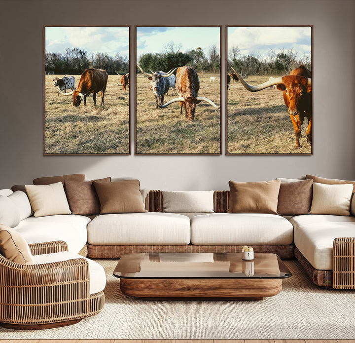 A herd of Texas Longhorn cattle grazing in an open field under a partly cloudy sky, capturing a rustic and Western ranch aesthetic.