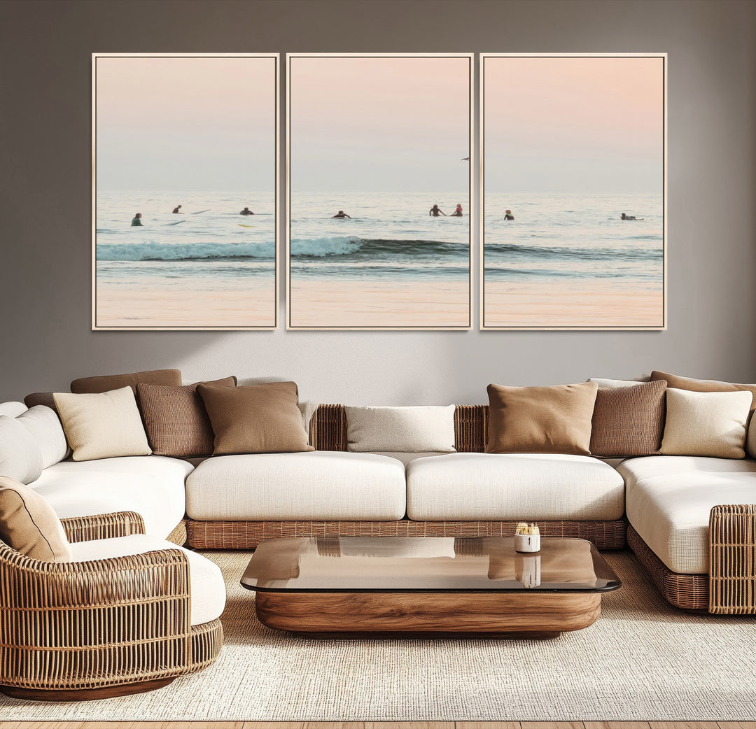Dreamy photo of surfers waiting on soft pastel waves under a pink sunset sky, ideal for soft coastal minimalist or serene ocean-themed home decor.