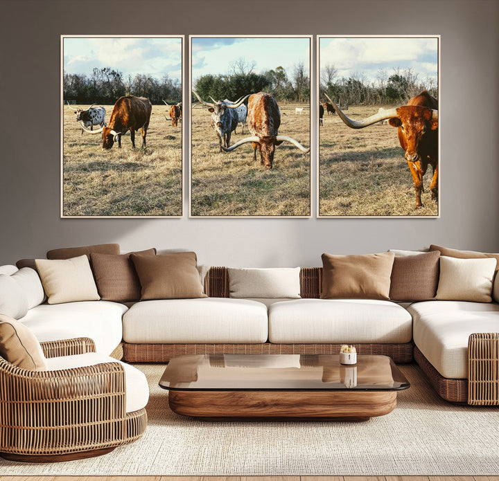 A herd of Texas Longhorn cattle grazing in an open field under a partly cloudy sky, capturing a rustic and Western ranch aesthetic.
