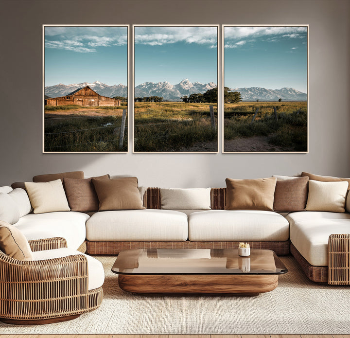 A rustic farmhouse with a wooden barn set against majestic mountain peaks under a soft blue sky, evoking peaceful countryside charm.