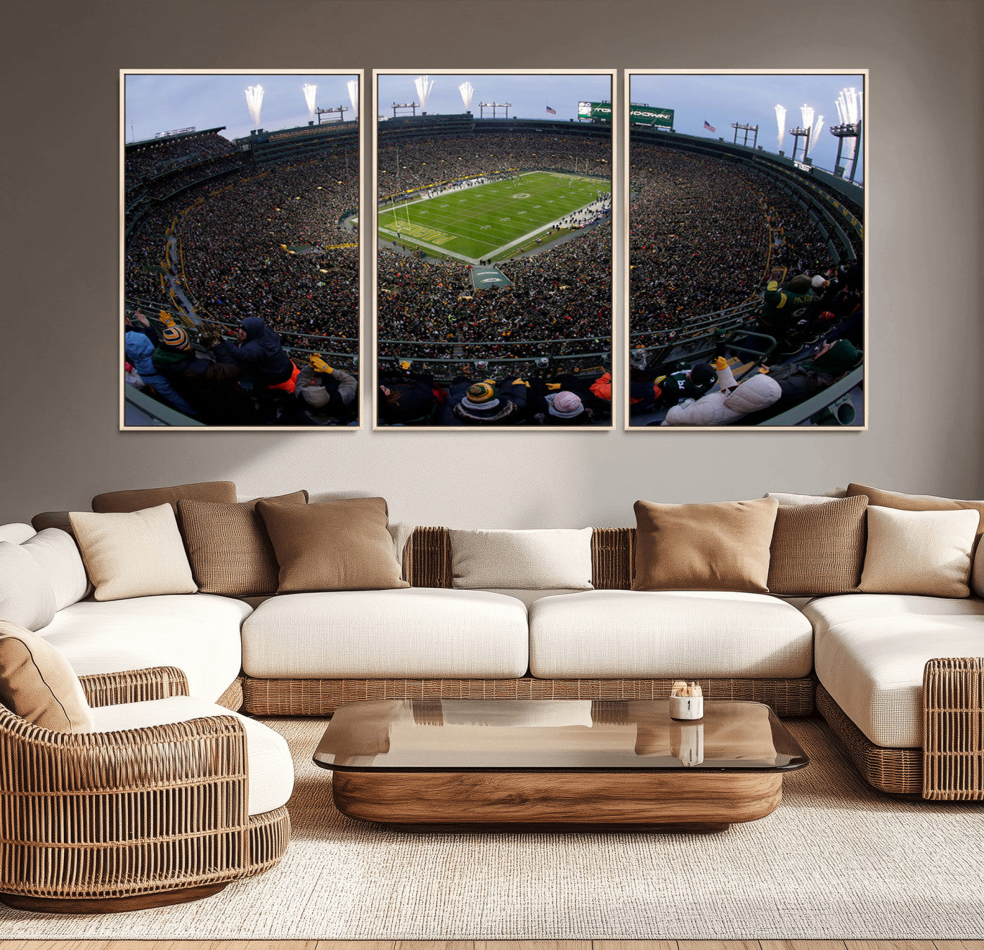 Wide fisheye view of a packed Lambeau Field stadium during an American football game. The crowd fills the stands, and fireworks are going off above the stadium lights. The scoreboard displays "Touchdown," and the field has "Packers" painted in the end zon