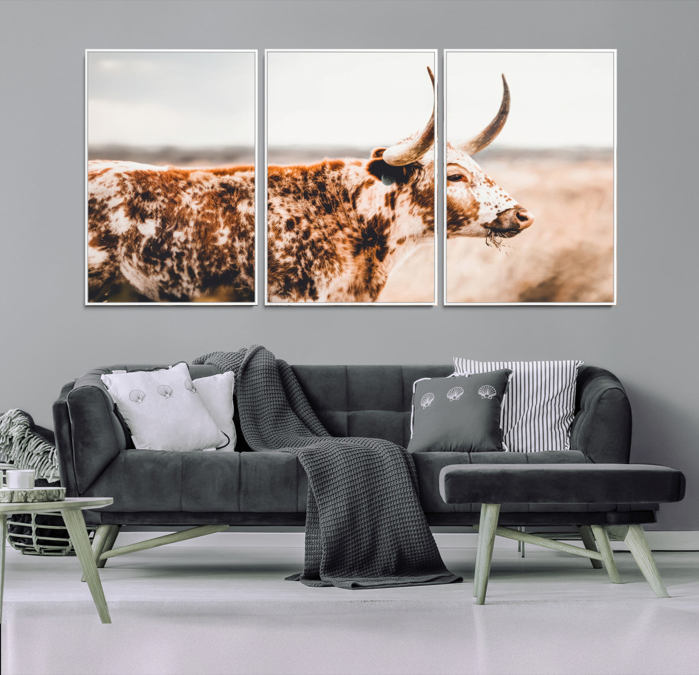 Speckled Texas longhorn with curved horns standing in a warm-toned prairie, perfect for rustic or country-style home decor.