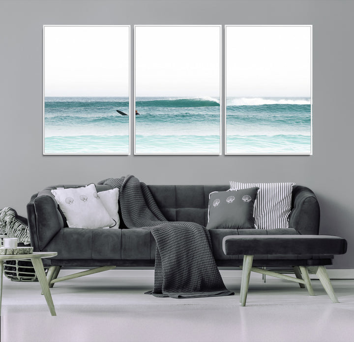 Minimalist photo of a lone surfer on calm aqua waves under bright sky, perfect for Scandinavian coastal or serene ocean-inspired home decor.