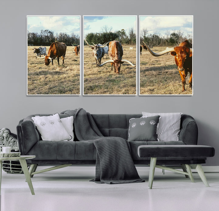 A herd of Texas Longhorn cattle grazing in an open field under a partly cloudy sky, capturing a rustic and Western ranch aesthetic.