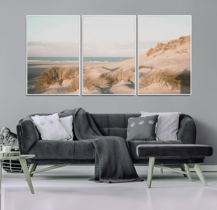 Soft pastel-toned beach scene with sand dunes, windswept grasses, and a calm ocean horizon, creating a serene coastal atmosphere.