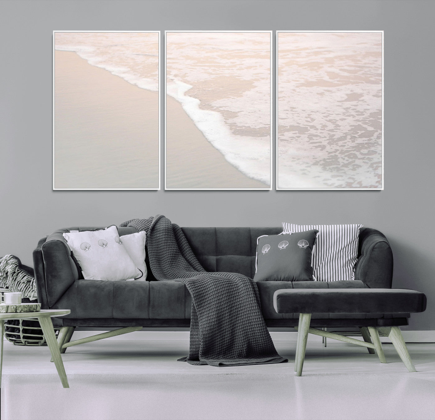 Close-up view of gentle ocean waves washing over smooth, wet sandy beach with soft foam along the shoreline.