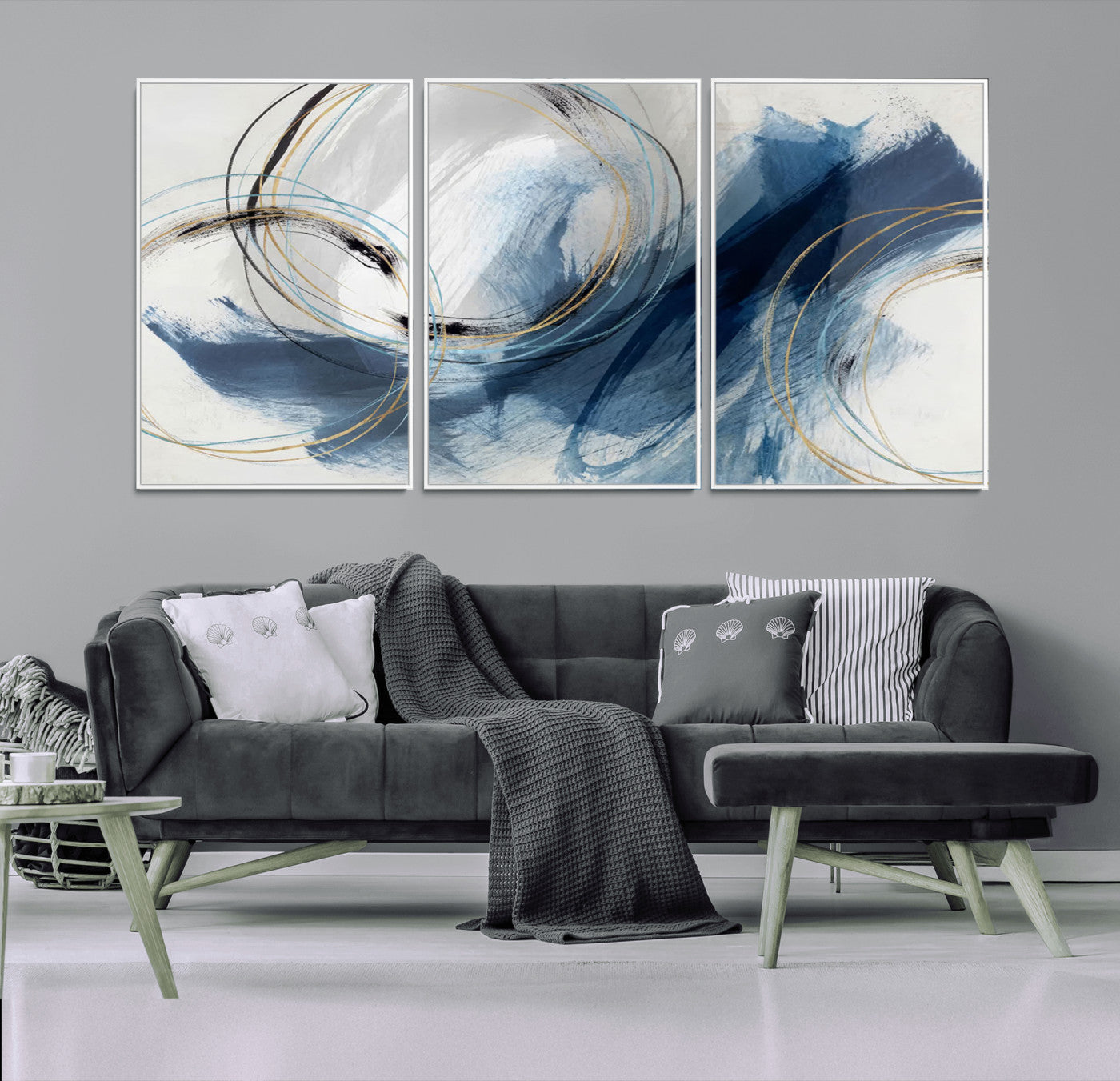 Abstract wall art featuring dynamic brush strokes in shades of blue and gray, overlaid with delicate circular line patterns in gold, black, and light blue on a white background.