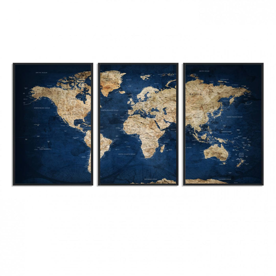 A large framed world map canvas print features beige landmasses set against a grunge-stained deep blue ocean background, creating an intriguing piece of wall art.