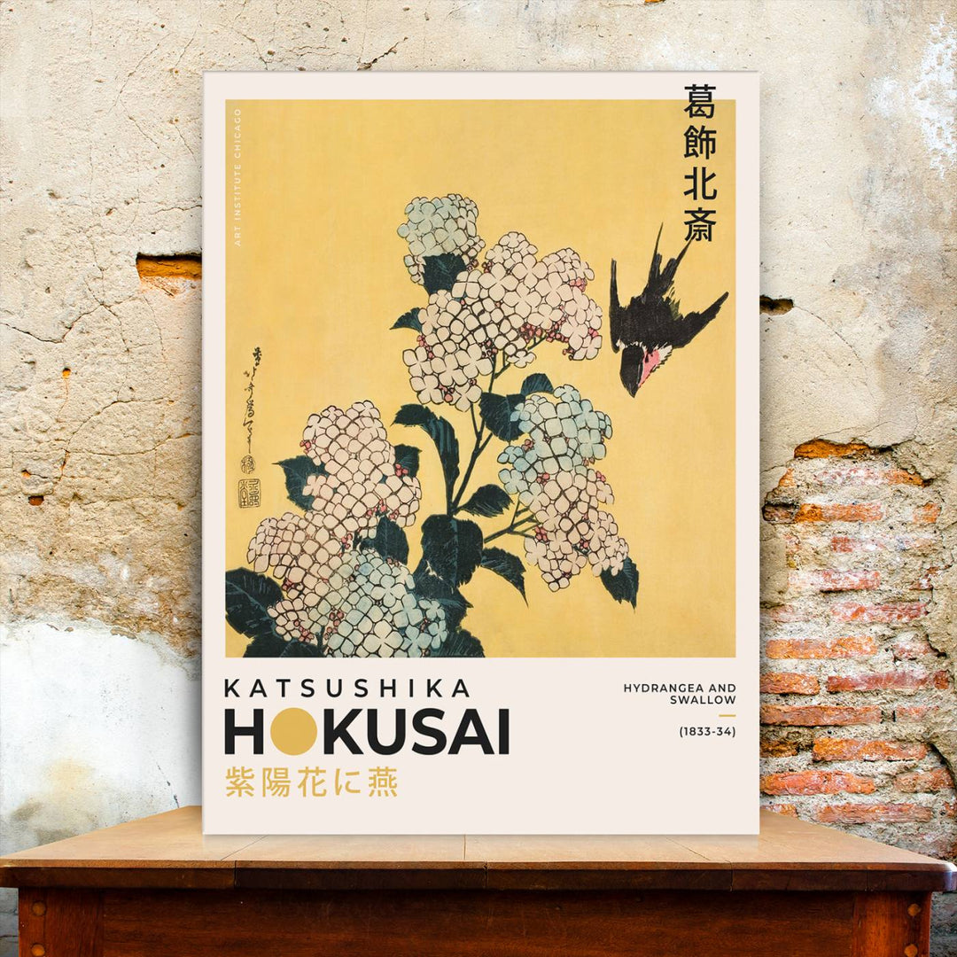 The Katsushika Hokusai Hydrangea and Swallow Canvas Wall Art Print highlights elegant Japanese floral art with a swallow, beautifully displayed against a textured wall. Ideal for adding charm to your living room, bedroom, or office.