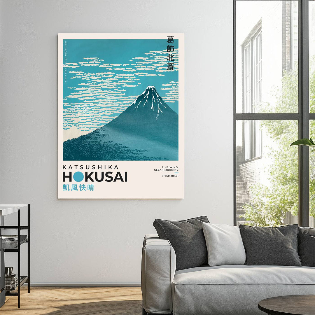 The Katsushika Hokusai Fine Wind, Clear Morning Canvas Wall Art Print, showcasing Mount Fuji with clouds, is displayed against a textured wall. This iconic Japanese art piece offers a premium canvas and gallery-quality finish that enhances any space as stunning wall decor.