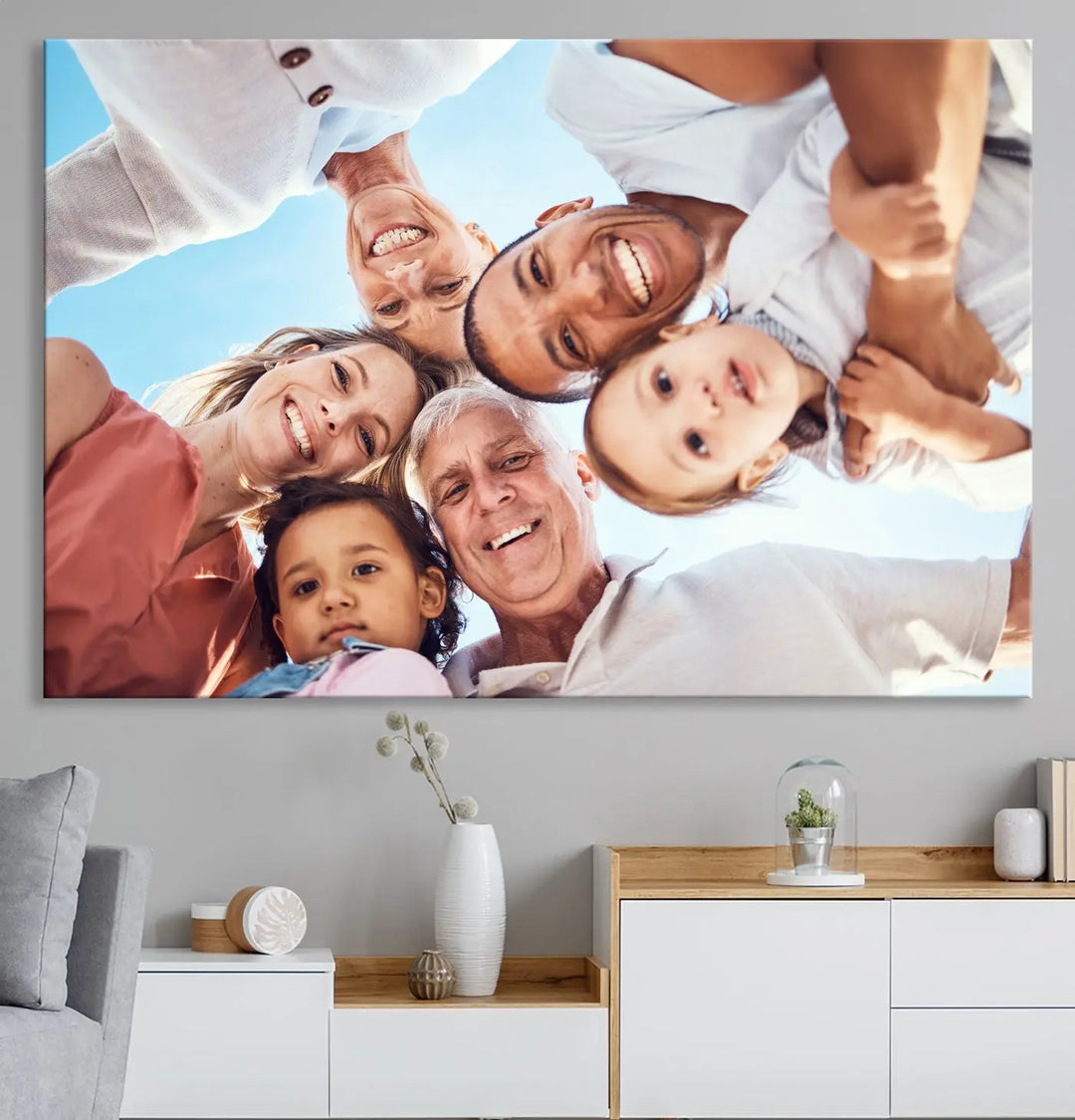 A group of six people smiles down in a circle, framed against a bright blue sky, reminiscent of the artistry found in the Jackson Pollock Abstract Wall Art Canvas Print.