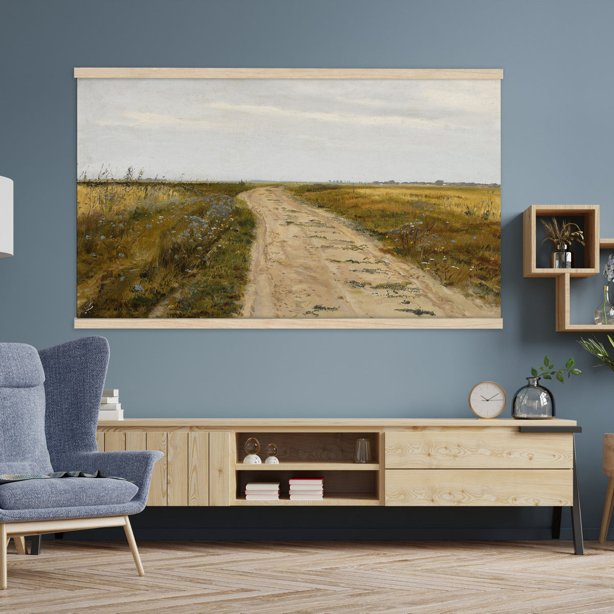 93198256-MGV-TP-30X20 - Realism oil painting tapestry wall hanging of "Field Track" by Jozef Chelmonski, showing a rutted dirt track cutting through open meadow grass toward a low horizon and a wide country sky in warm earth track tones with green meadow grass under a broad sky. Extra large wall art, made in the USA.
