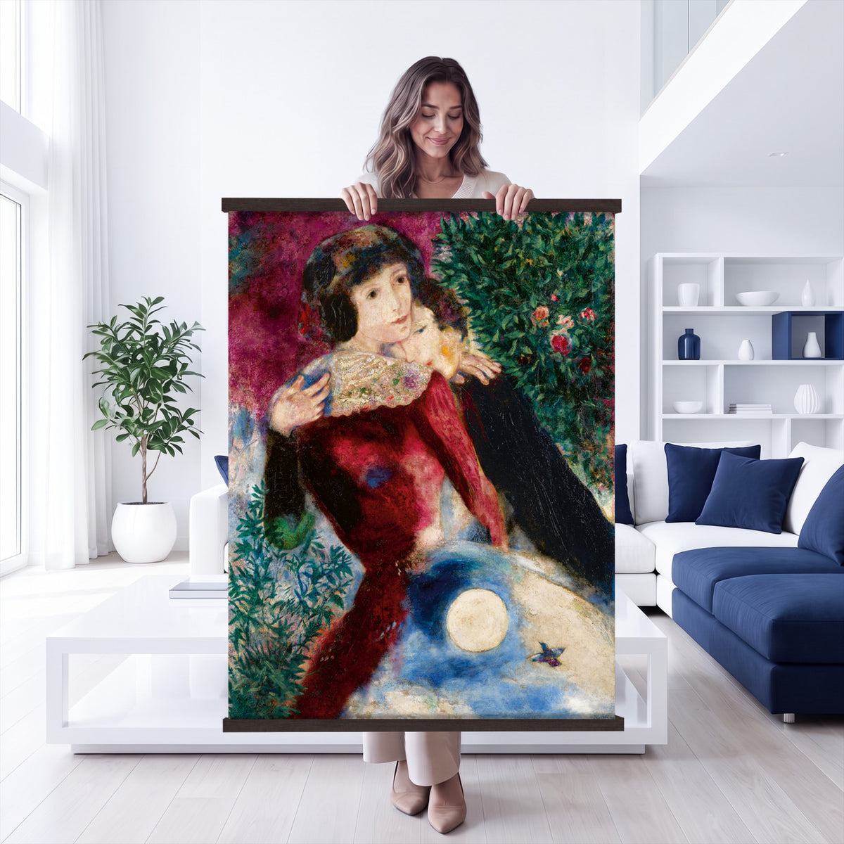67037419-MGV-TP-24X36 - Surrealism oil painting tapestry wall hanging of "Bella with a White Collar" by Marc Chagall, showing a towering figure in a white collar above a small embracing couple, set under a soft moonlit sky in deep green foliage and soft blue sky with a pale white collar. Extra large wall art, made in the USA.