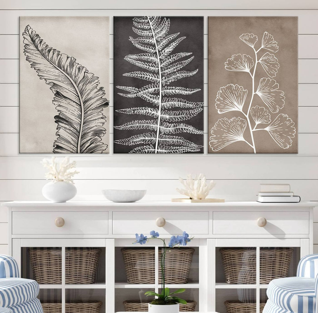 Three framed botanical wall art pieces are displayed in a bright room.