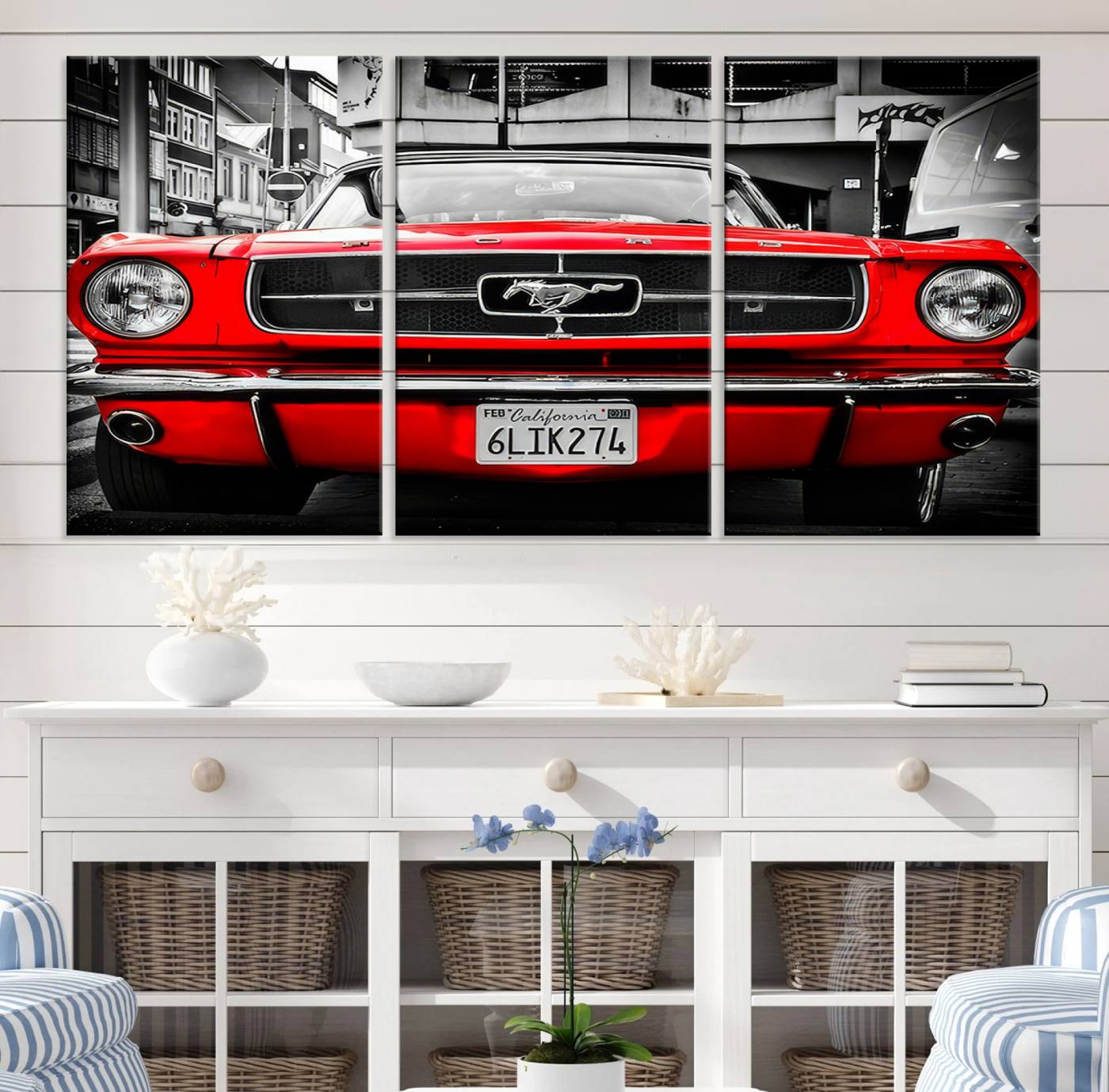 Front view of a bold red 1960s Ford Mustang parked in an urban environment, captured in dramatic contrast with a black-and-white city backdrop, emphasizing its timeless American muscle car identity.