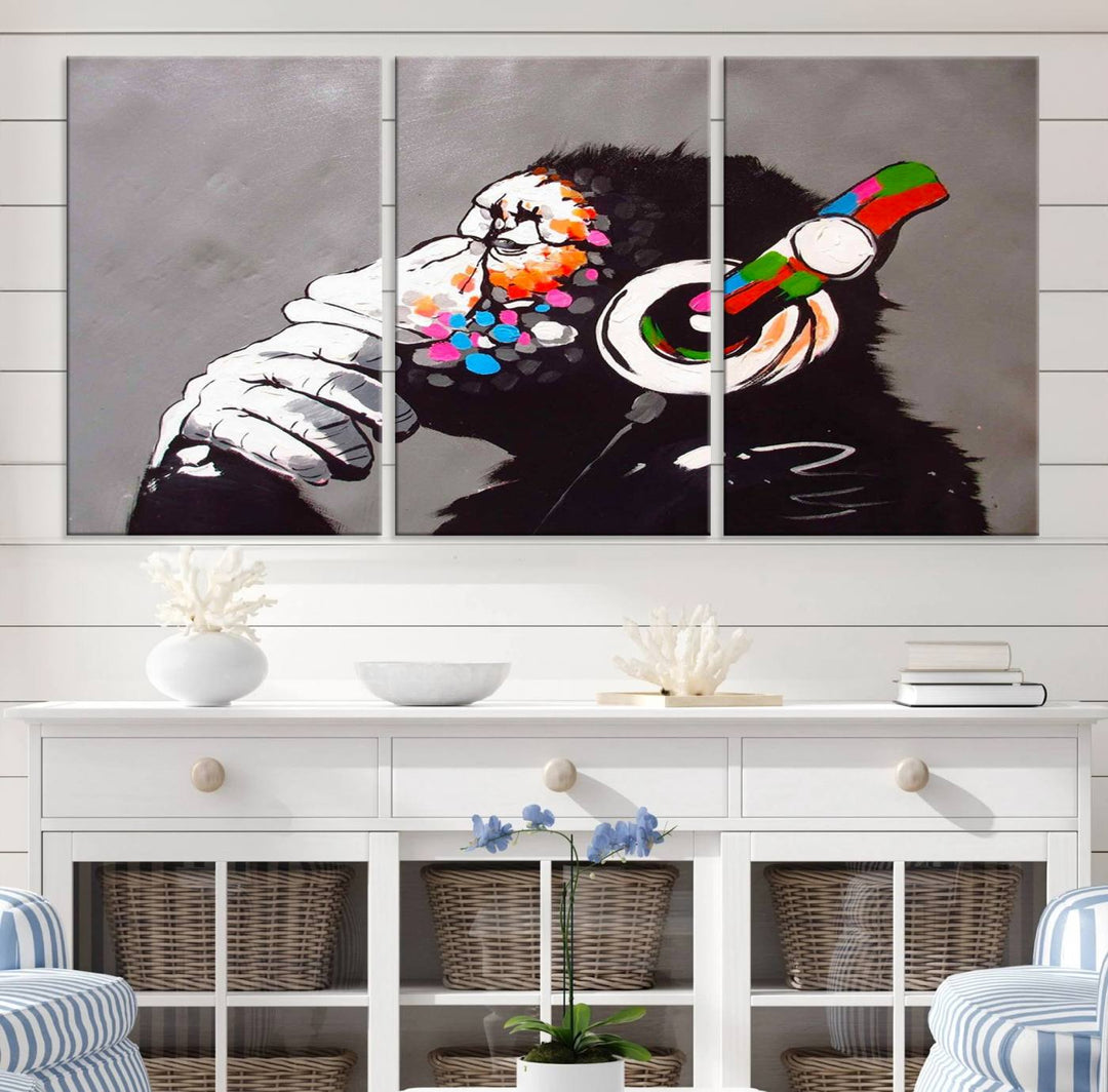 A vibrant triptych, the "DJ Monkey Listening to Music" wall art print, features a Banksy-inspired large canvas adorned with colorful modern pop art. This striking piece elegantly enhances the room with its dynamic and lively depiction.