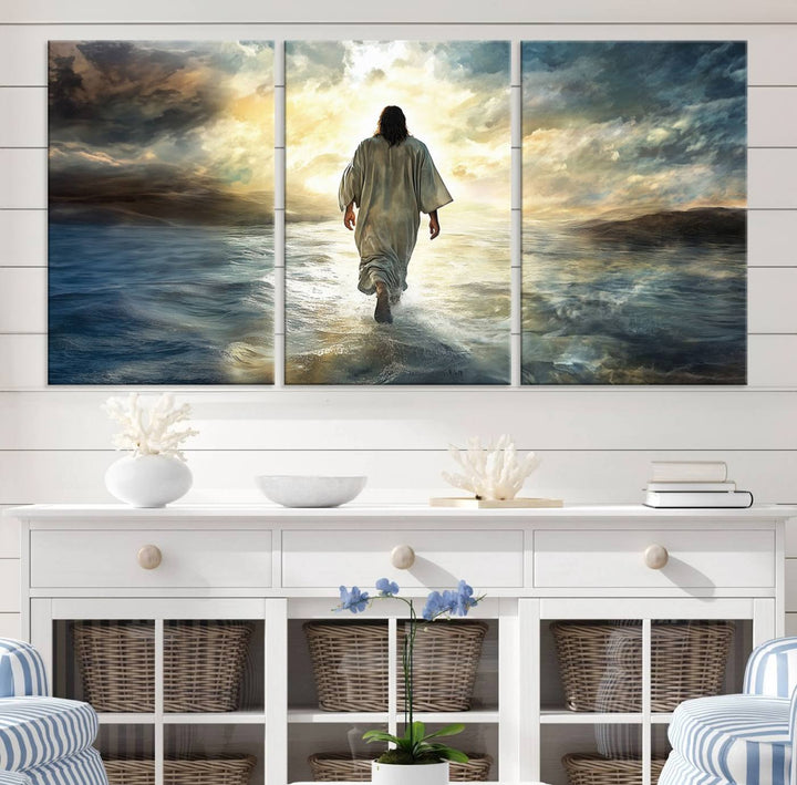 The Jesus Walking on Water Wall Art, a captivating triptych canvas print, showcases a person walking on water beneath dramatic clouds. This ready-to-hang piece seamlessly combines faith and style for your Christian home decor.