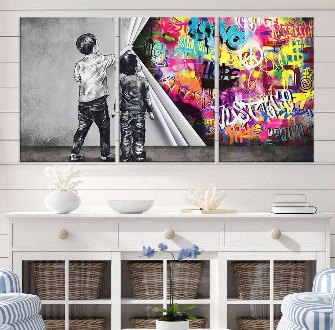 The Banksy Print - Street Art Canvas features a vibrant and bold image of two children lifting a curtain to reveal colorful graffiti. It's ready to hang, adding an urban modern decor vibe.