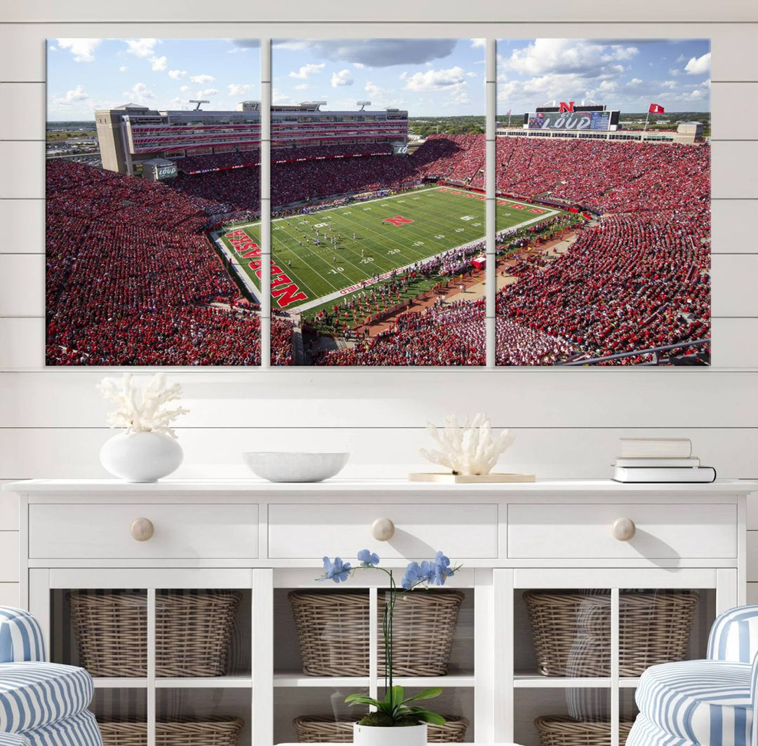 The University of Nebraska Cornhuskers Football Team Print showcases a vibrant triptych of Lincoln Memorial Stadium, depicting a packed football stadium filled with energetic fans. This handmade art piece is crafted in the USA and printed on premium canvas for a gallery-quality finish.